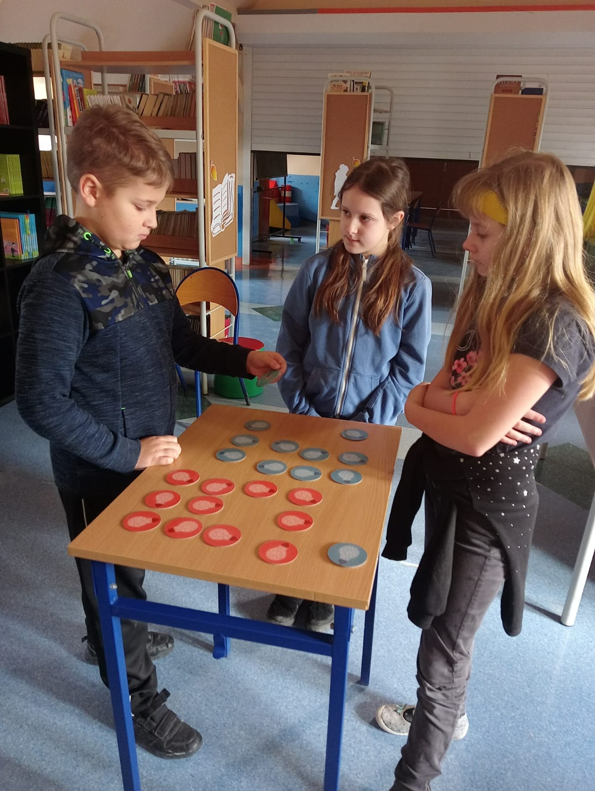 Tekst alternatywny: uczniowie grają w grę w bibliotece szkolnej